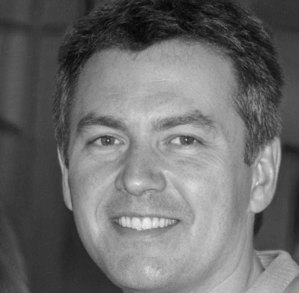 Professional headshot of Somchai Rattanakorn, financial systems expert and former banking executive